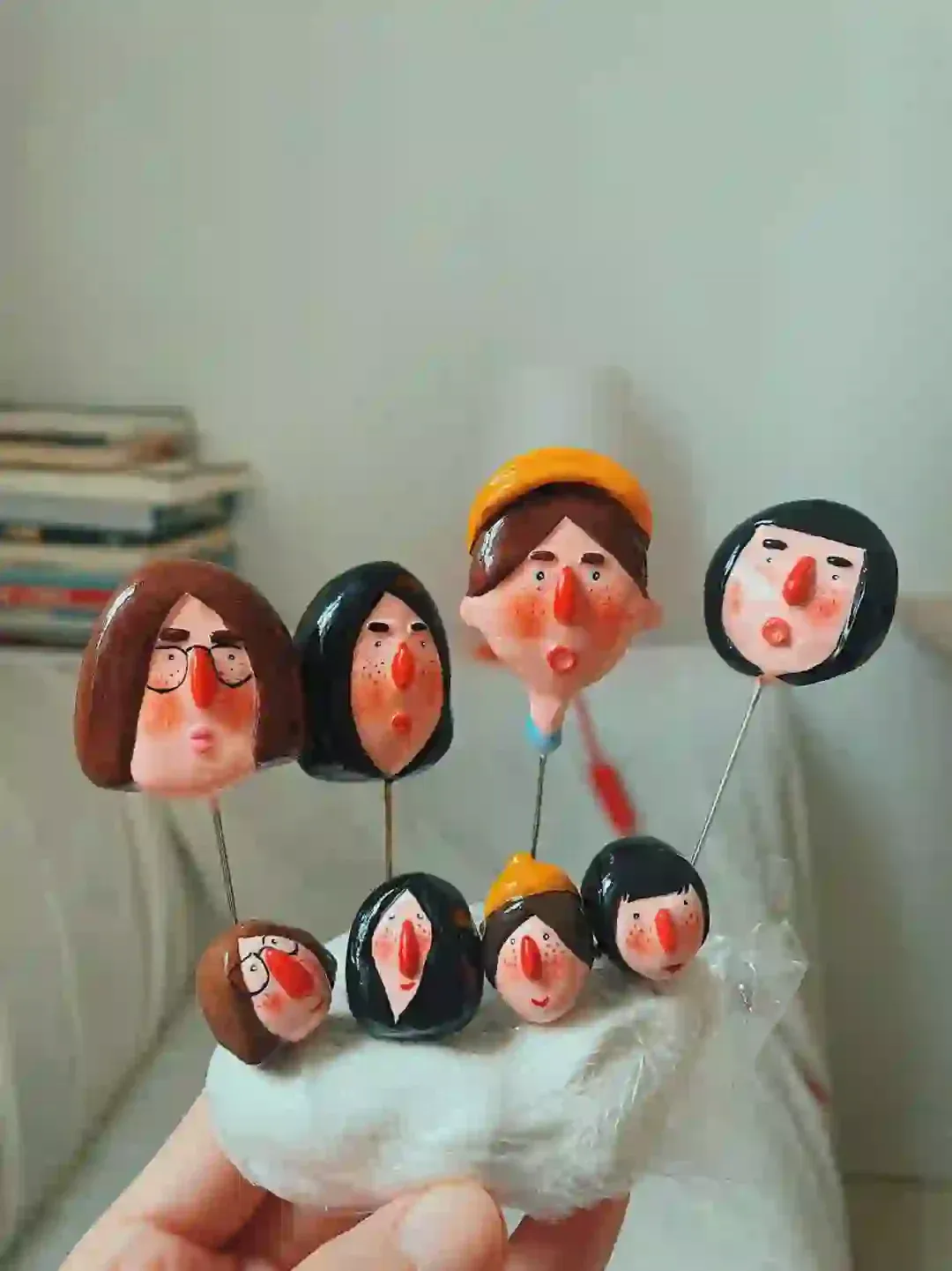 Hand-held collection of character brooches and rings