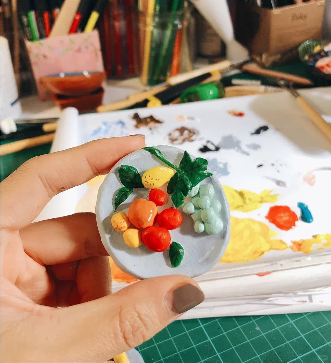Hand-held clay fruit relief during the making process
