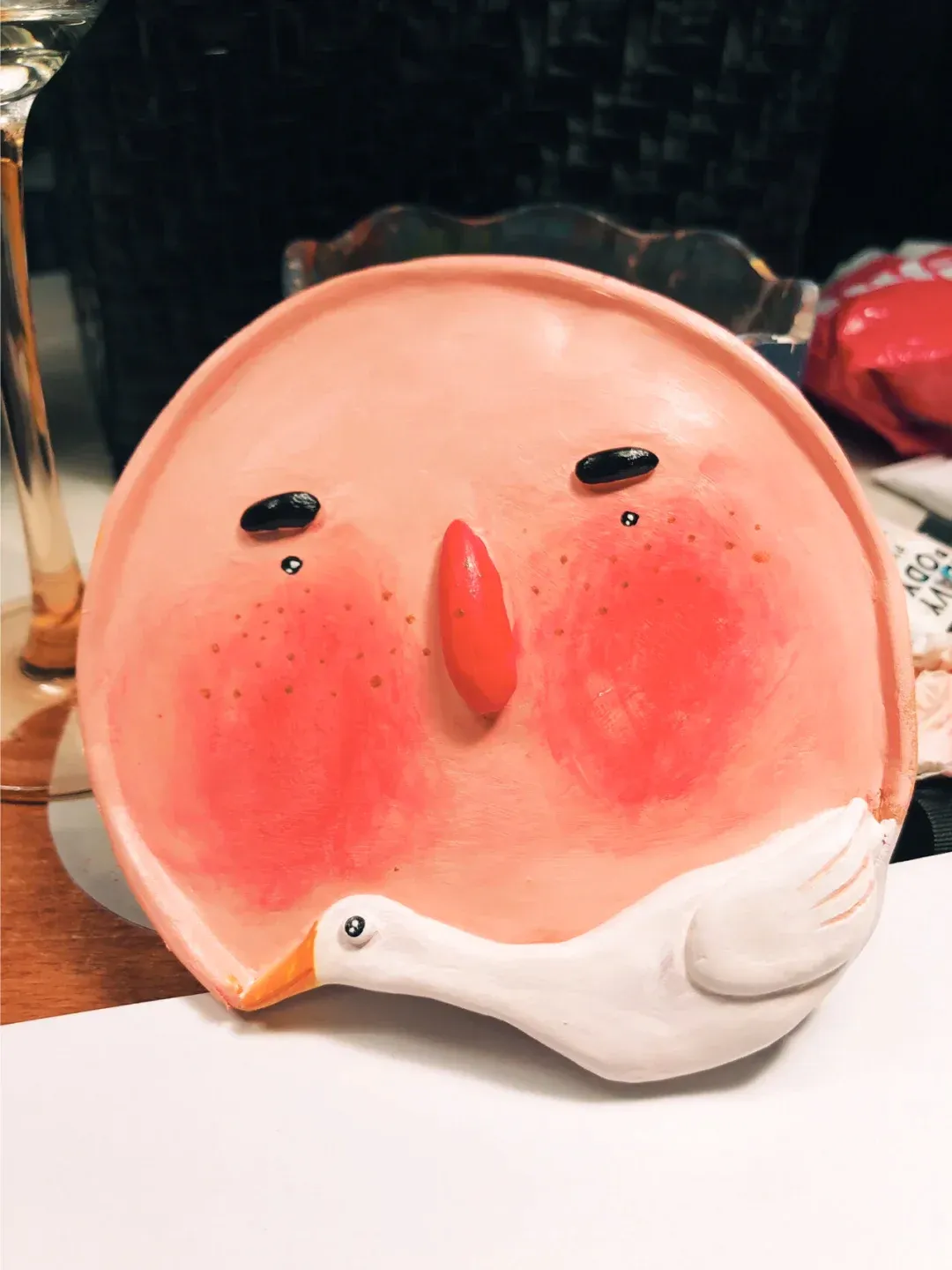Handmade character plate with a small white bird relief