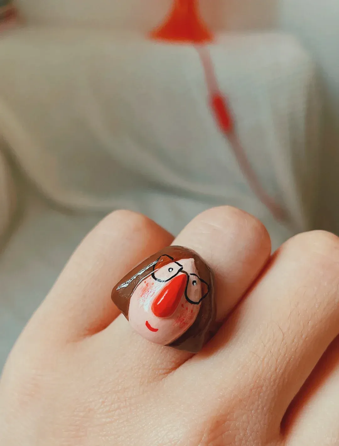 Handmade character ring worn on a hand
