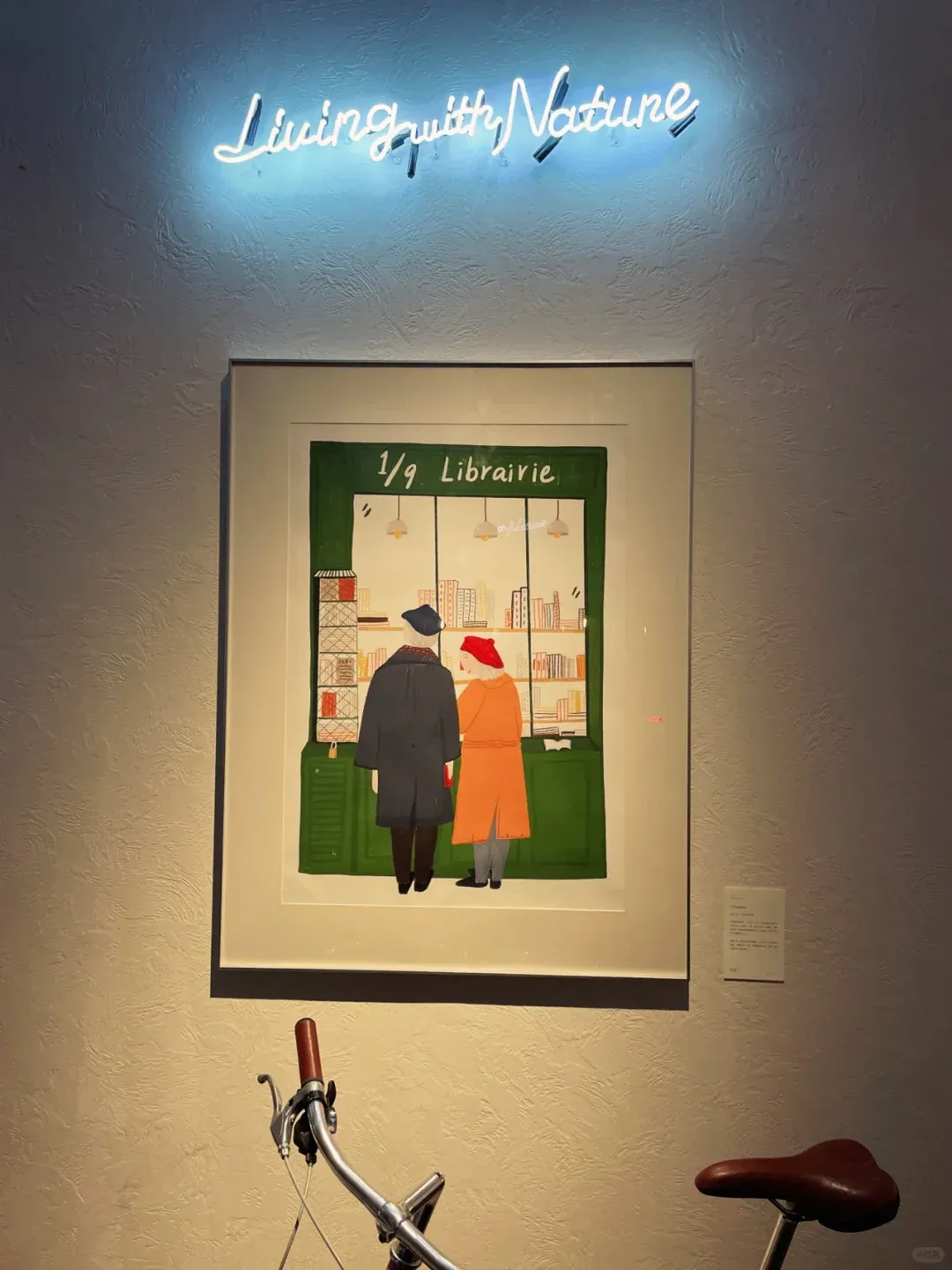 Framed Paris bookshop illustration displayed in a Shanghai exhibition space